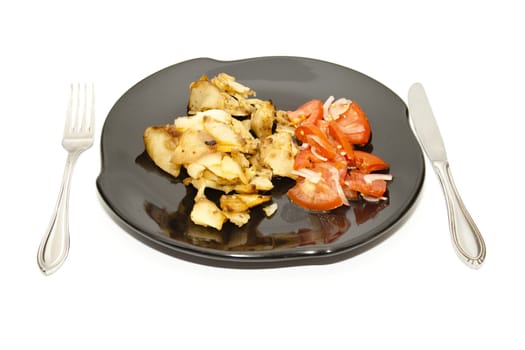 Roasted Potatoes with Tomato Salad on ceramic Plate