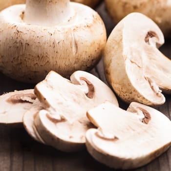 Champignons and slices on the wooden table closeup