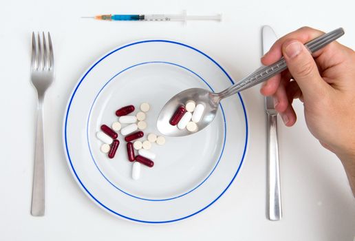 Medical Soup of pills Man holding spoon full of tablets
