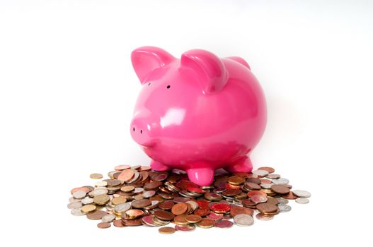 Pink Piggy bank sitting on coins 