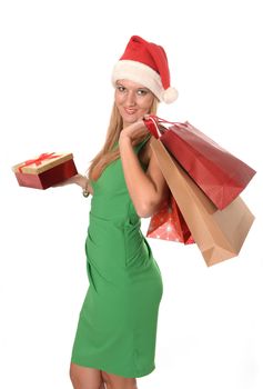 Young beautiful woman in Santa Claus hat with Christmas shopping bags