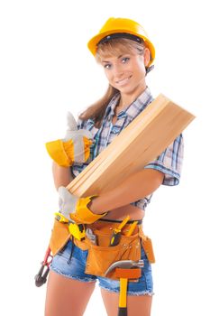Portrait of young female construction worker carrying wooden boards on arm against white background