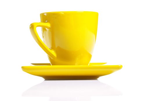 yellow coffee cup on saucer isolated on white background