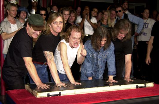 Cliff Williams, Brian Johnson, Angus Young, Malcolm Young at the ceremony where they were inducted into Sunset Blvd's Rockwalk. 09-15-00