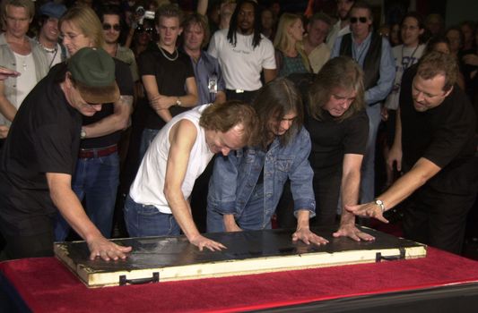 Cliff Williams, Brian Johnson, Angus Young, Malcolm Young at the ceremony where they were inducted into Sunset Blvd's Rockwalk. 09-15-00