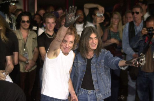 Angus Young, Malcolm Young at the ceremony where they were inducted into Sunset Blvd's Rockwalk. 09-15-00