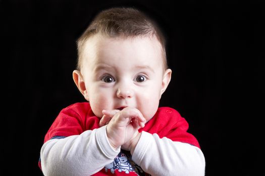 Baby boy on black background