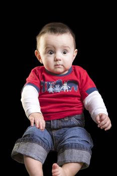 Baby boy on black background