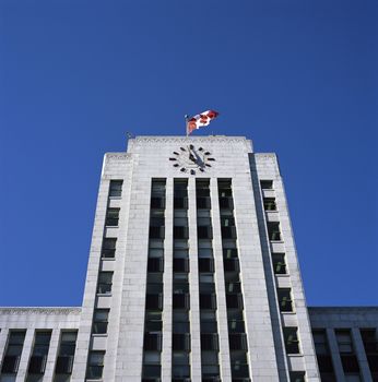 Large city hall building with canadian flag