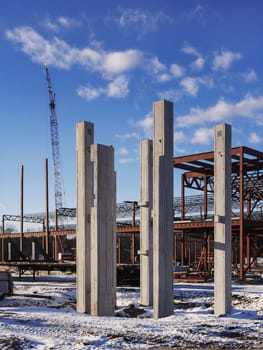 new commercial building construction site with concrete beams in foreground