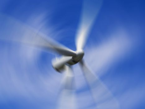 giant wind turbine blades spinning against a blue sky