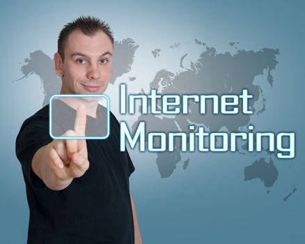 Young man press digital Internet Monitoring button on interface in front of him
