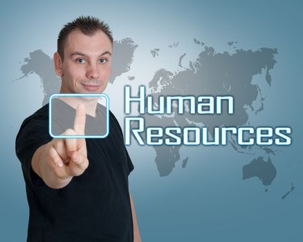Young man press digital Human Resources button on interface in front of him