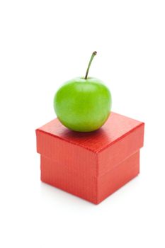 red gift box and green plum isolated on white