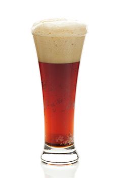 dark beer with the foam in a tall glass isolated on white