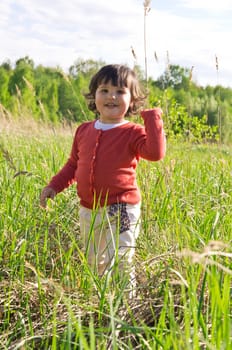 Smiling little girl on meadow