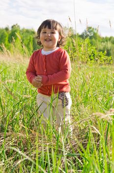 Happy little girl on meadow