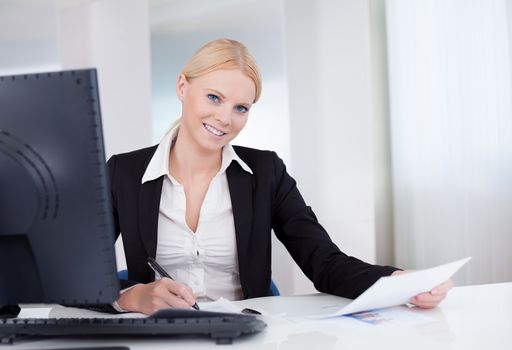 Successful young businesswoman working in the office