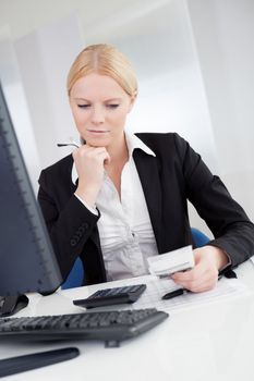 Cheerful accountant businesswoman working in the office