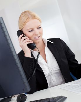 Beautiful businesswomen talking on the phone in the office