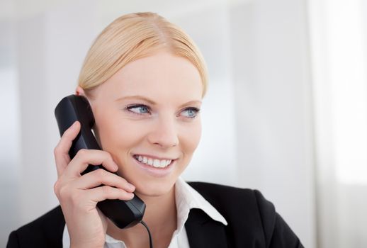 Beautiful businesswomen talking on the phone in the office