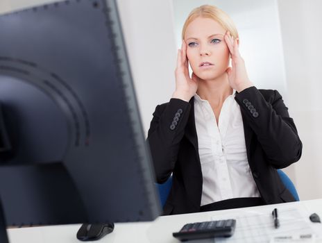 Cheerful young businesswoman with headache working in the office