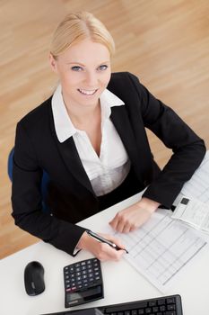 Cheerful accountant businesswoman working in the office