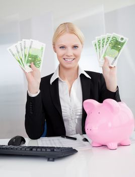 Businesswoman holding euro currency notes in the office