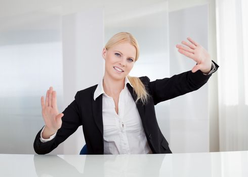 Beautiful businesswoman touching the screen with her finger