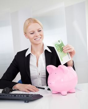 Businesswoman holding euro currency notes in the office