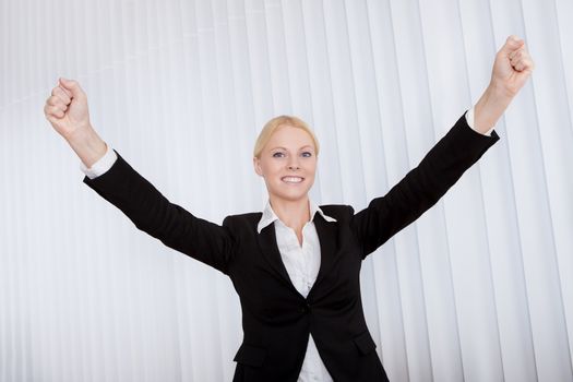 Portrait of cheerful young businesswoman in the office