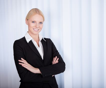 Portrait of cheerful young businesswoman in the office