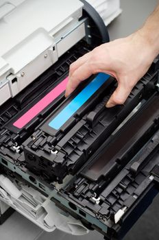 Man puts toner in the printer