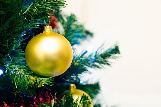 Closeup of christmas decoration. Golden bauble on xmas tree