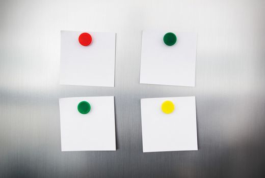 White reminders with magnets on fridge