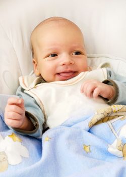 Newborn baby boy smiling 