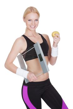 Beautiful young fitness woman with weights and apple. Isolated on white