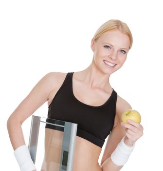 Beautiful young fitness woman with weights and apple. Isolated on white