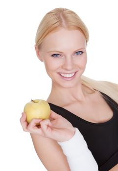 Beautiful young fitness woman holding apple. Isolated on white