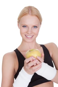 Beautiful young fitness woman holding apple. Isolated on white