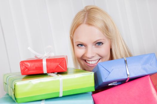 Beautiful young woman with her presents on the sofa