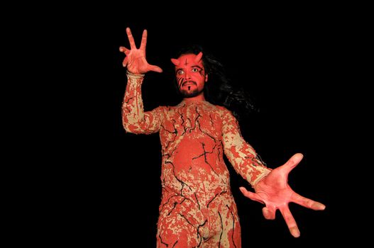 Latin American Man with Long Hairs Masked as a Devil in the Desert