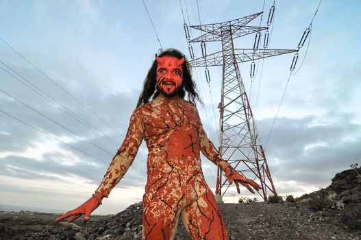 Latin American Man with Long Hairs Masked as a Devil in the Desert