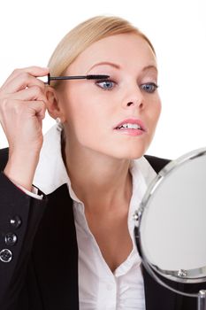 Attractive businesswoman applying mascara. Isolated on white