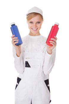 Professional young painter woman holding two buckets of paint. Isolated on white