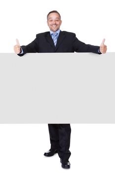 Happy Businessman Holding Blank Billboard On White Background