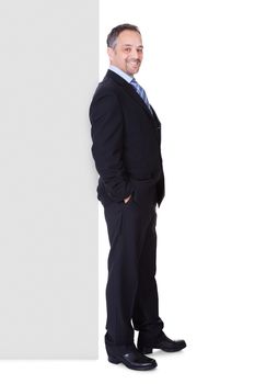 Happy Businessman Holding Blank Billboard On White Background