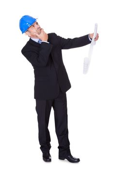 Happy Male Architect Looking At Blueprint On White Background