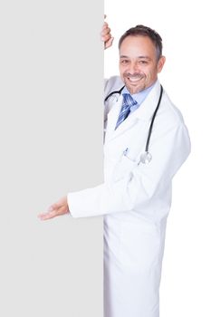 Portrait Of A Doctor Holding Blank Placard Isolated On White Background