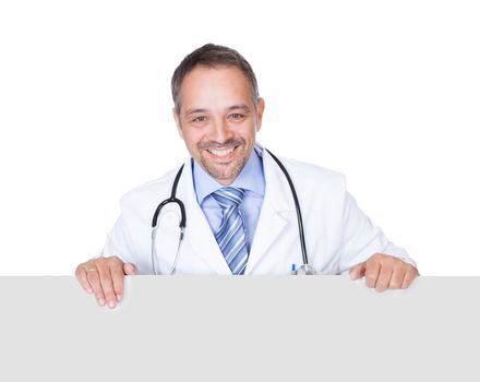 Portrait Of A Doctor Holding Blank Placard Isolated On White Background